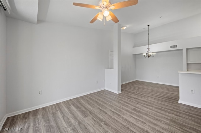 unfurnished living room with hardwood / wood-style flooring and ceiling fan with notable chandelier