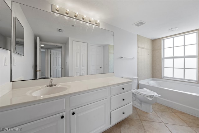 bathroom featuring vanity, a bathtub, toilet, and tile patterned floors