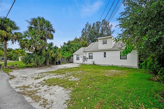 rear view of property with a lawn