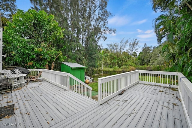 wooden terrace with a storage shed