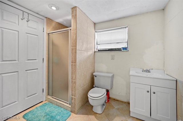 bathroom featuring a shower with door, toilet, tile patterned floors, and vanity