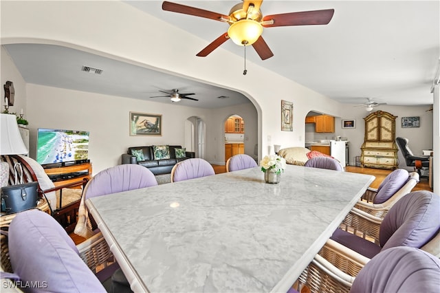 dining space with hardwood / wood-style floors and ceiling fan