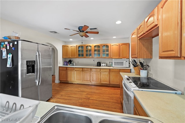 kitchen featuring white appliances, light hardwood / wood-style floors, and ceiling fan