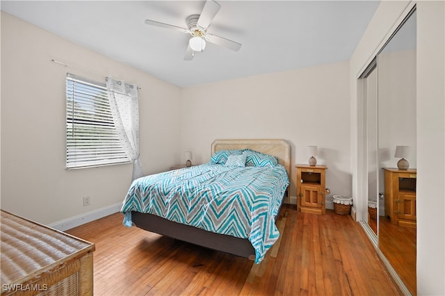 bedroom featuring hardwood / wood-style flooring, a closet, and ceiling fan