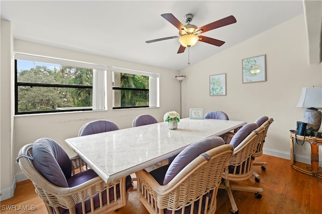 dining room featuring lofted ceiling, hardwood / wood-style flooring, and ceiling fan