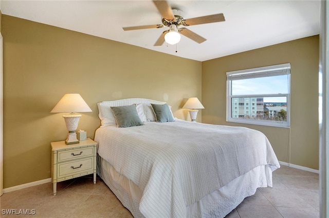 tiled bedroom featuring ceiling fan