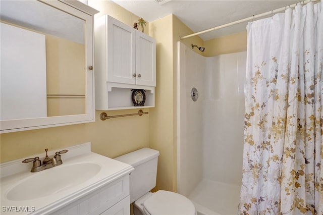 bathroom featuring vanity, toilet, and a shower with shower curtain