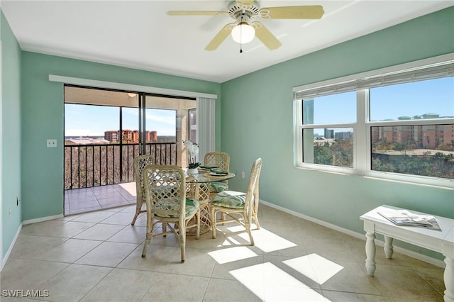 tiled dining room featuring ceiling fan