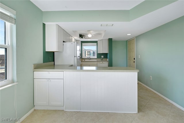 6893 Estero Blvd Unit 456, Fort Myers Beach, FL 33931 - kitchen with white appliances, a peninsula, a sink, baseboards, and light tile patterned floors