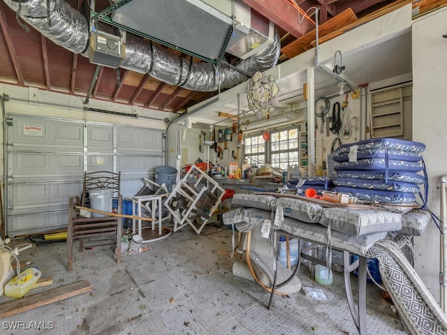 garage with a workshop area and a garage door opener