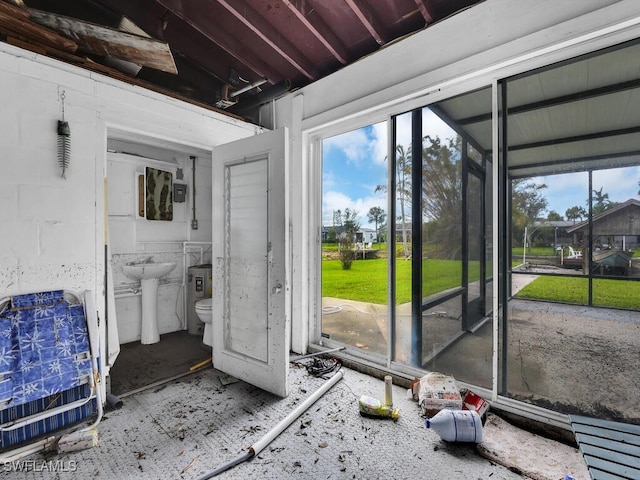 bathroom featuring toilet, sink, and a wealth of natural light