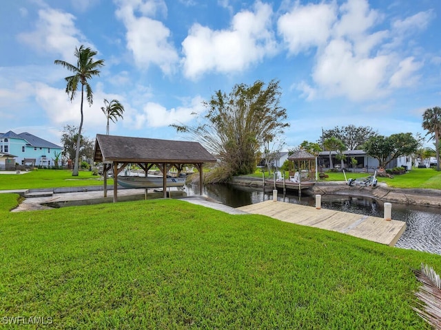 dock area with a water view and a yard