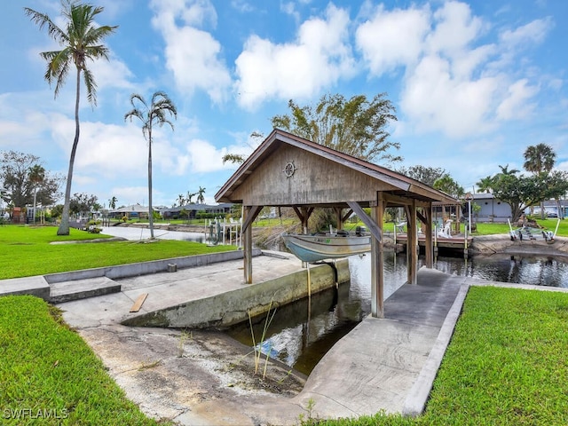 dock area with a water view and a yard