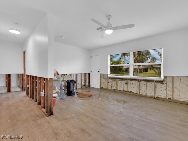 unfurnished room with ceiling fan and light wood-type flooring