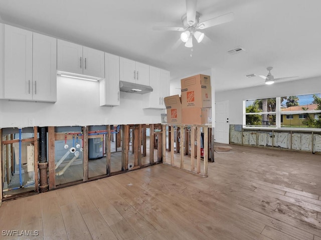 kitchen with light hardwood / wood-style flooring, white cabinets, water heater, and ceiling fan