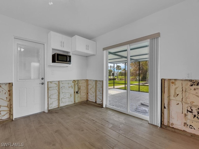 kitchen featuring light hardwood / wood-style flooring and white cabinetry