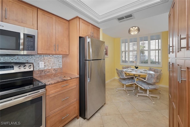 kitchen featuring stainless steel appliances, crown molding, light stone countertops, light tile patterned floors, and tasteful backsplash