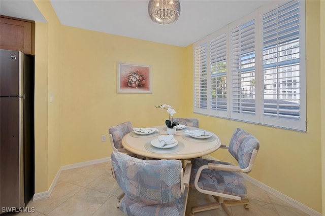 dining space featuring light tile patterned flooring