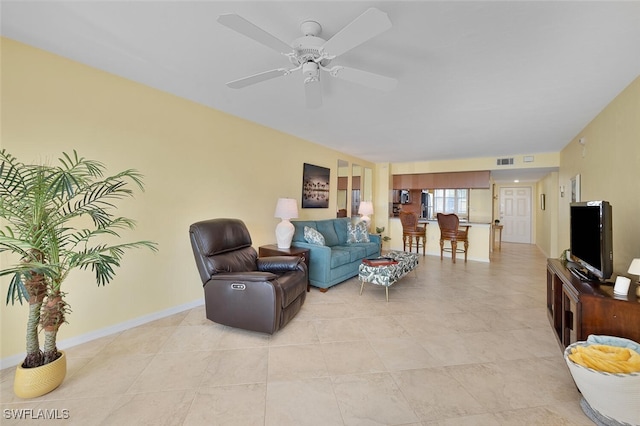 tiled living room with ceiling fan