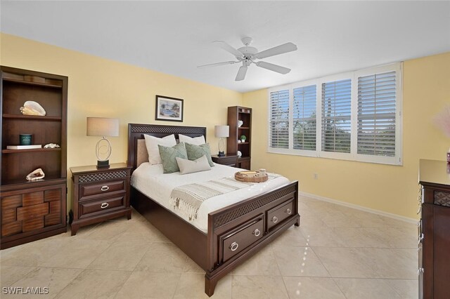 bedroom with ceiling fan and light tile patterned floors