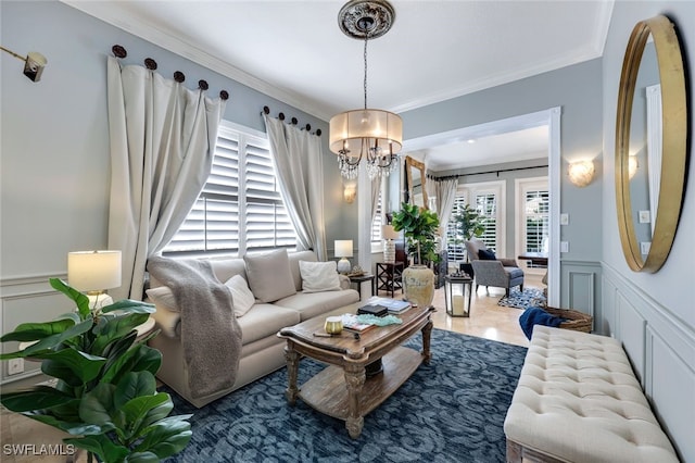 living room featuring crown molding and a notable chandelier