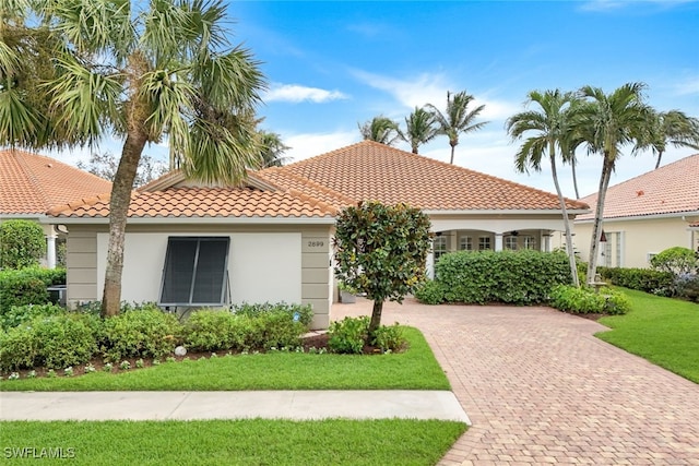 mediterranean / spanish home with a front yard