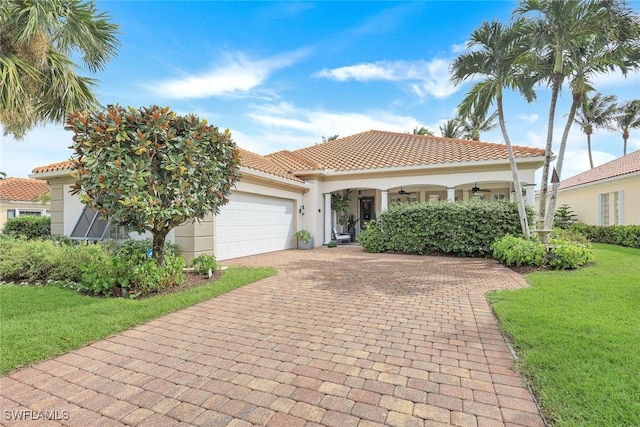 mediterranean / spanish-style house with a front yard and a garage