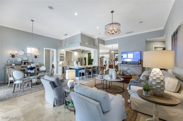 living room featuring an inviting chandelier and ornamental molding