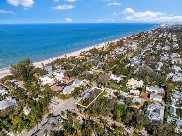 bird's eye view with a water view and a view of the beach