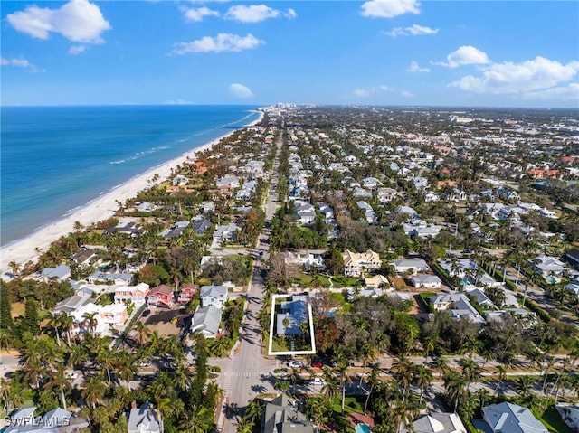 drone / aerial view featuring a water view and a view of the beach