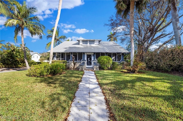 view of front of home with a front lawn and a sunroom