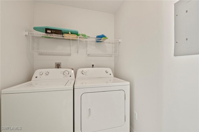 laundry room featuring washing machine and dryer and electric panel