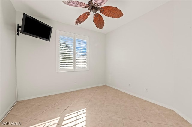 tiled spare room featuring ceiling fan