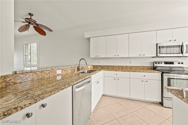 kitchen with ceiling fan, appliances with stainless steel finishes, stone counters, white cabinets, and sink