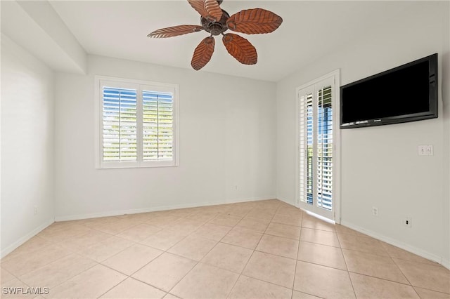 tiled spare room featuring ceiling fan