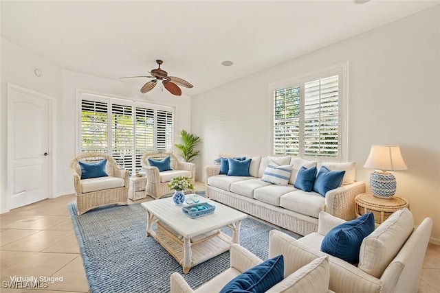 living room featuring ceiling fan, light tile patterned flooring, and a healthy amount of sunlight