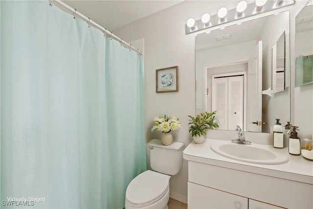 bathroom with toilet and vanity