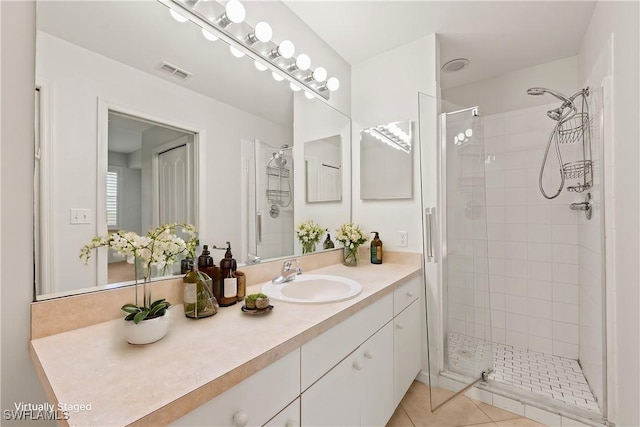 bathroom featuring vanity, tile patterned flooring, and an enclosed shower