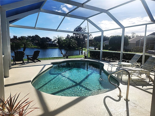 view of swimming pool with glass enclosure, a water view, and a patio