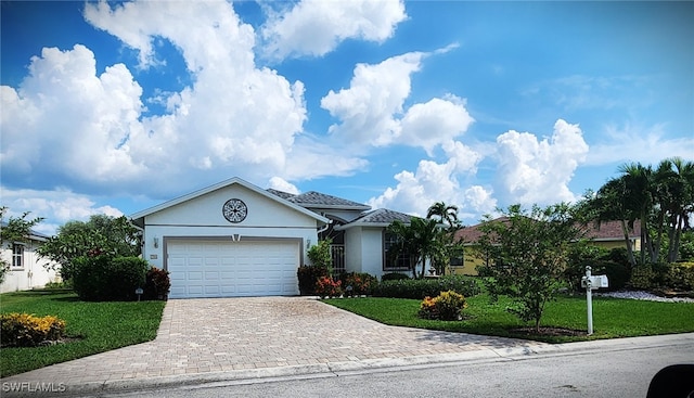 ranch-style house featuring a garage and a front lawn