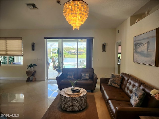 living room featuring a chandelier, a textured ceiling, and a wealth of natural light