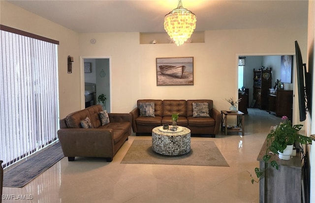 living room with a chandelier and light tile patterned floors