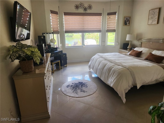 bedroom with light tile patterned floors