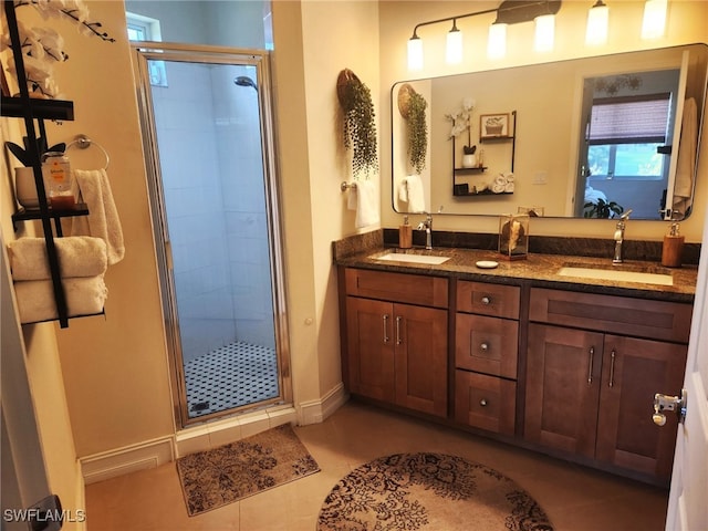 bathroom with tile patterned floors, vanity, and an enclosed shower