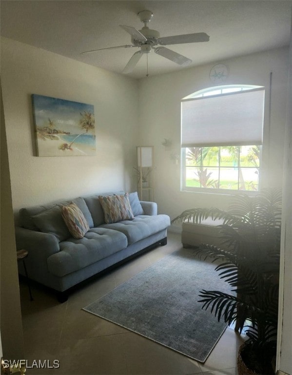 tiled living room with ceiling fan