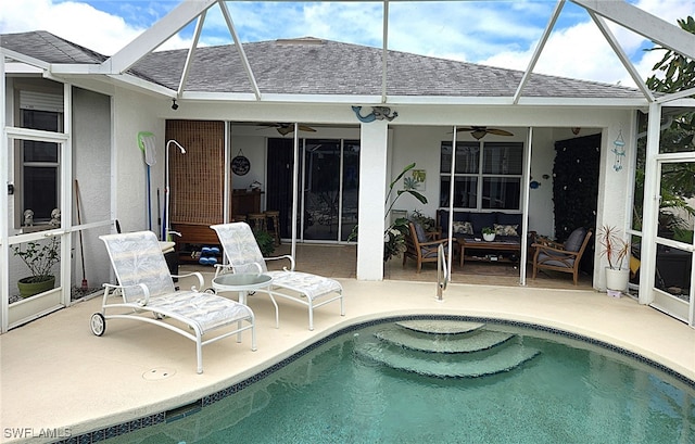 view of swimming pool featuring a lanai, a patio area, and ceiling fan