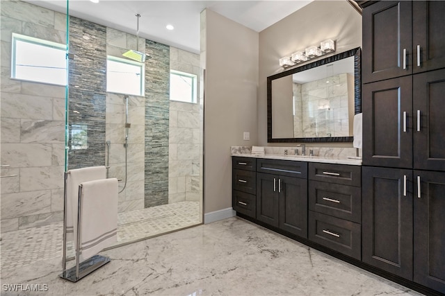 bathroom featuring tiled shower and vanity