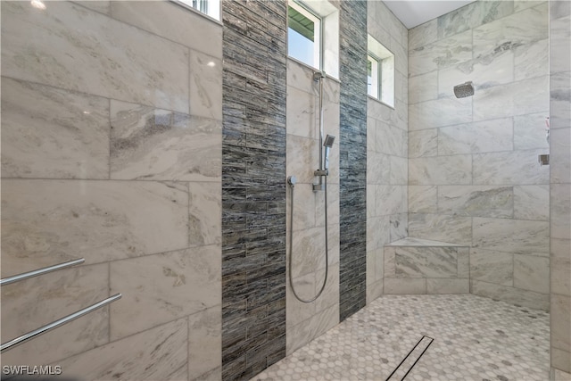 bathroom with a tile shower