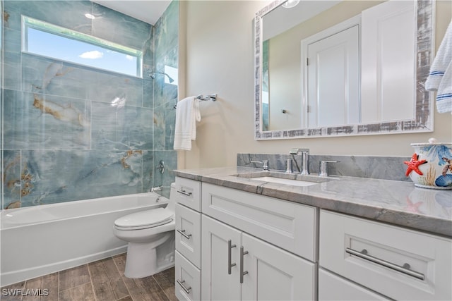 full bathroom with vanity, toilet, and tiled shower / bath