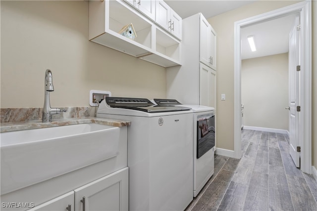 clothes washing area featuring sink, independent washer and dryer, and cabinets